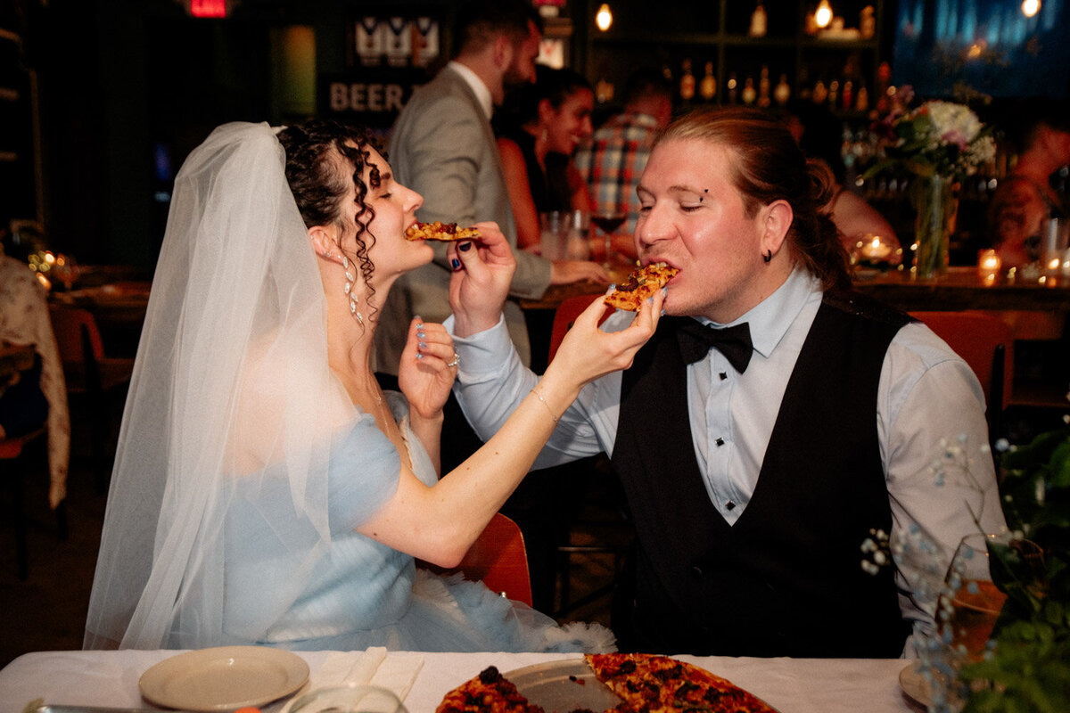 Couple share. a slice of pizza at COlumbus Brewery