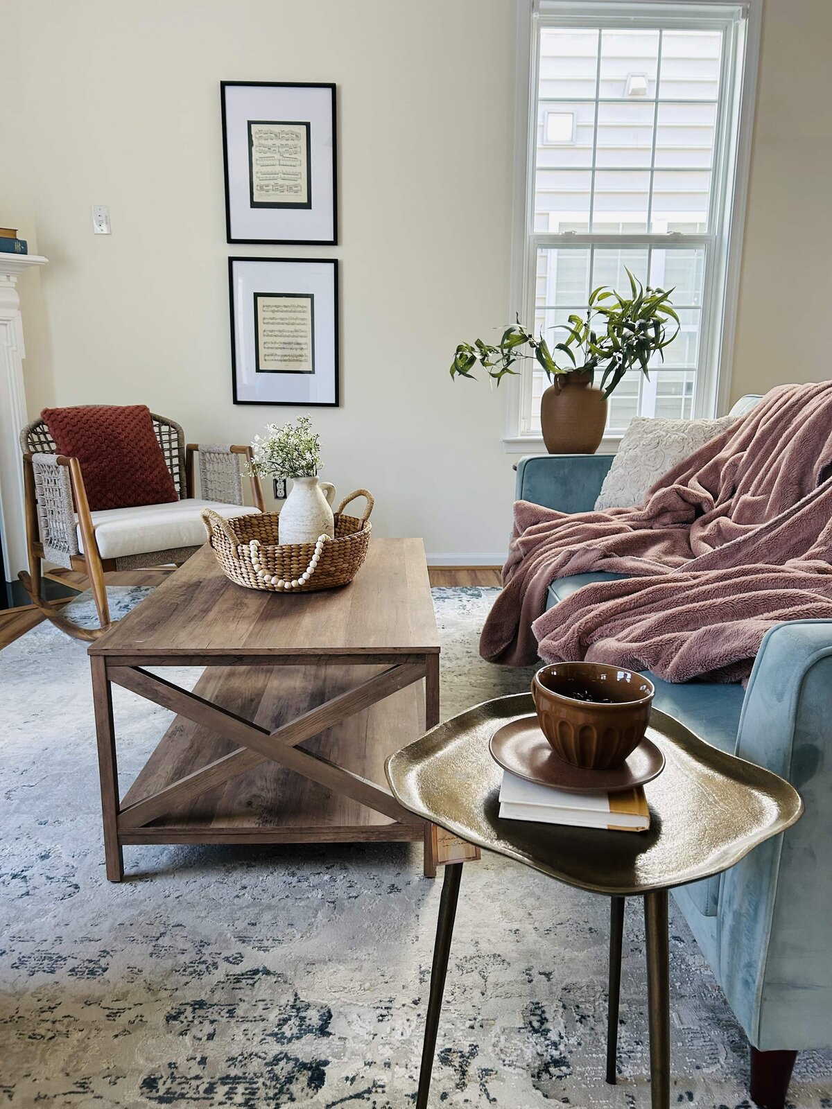 Coffee table with fresh flowers, accent chairs, and styled décor — warm and inviting Williamsburg home staging detail.