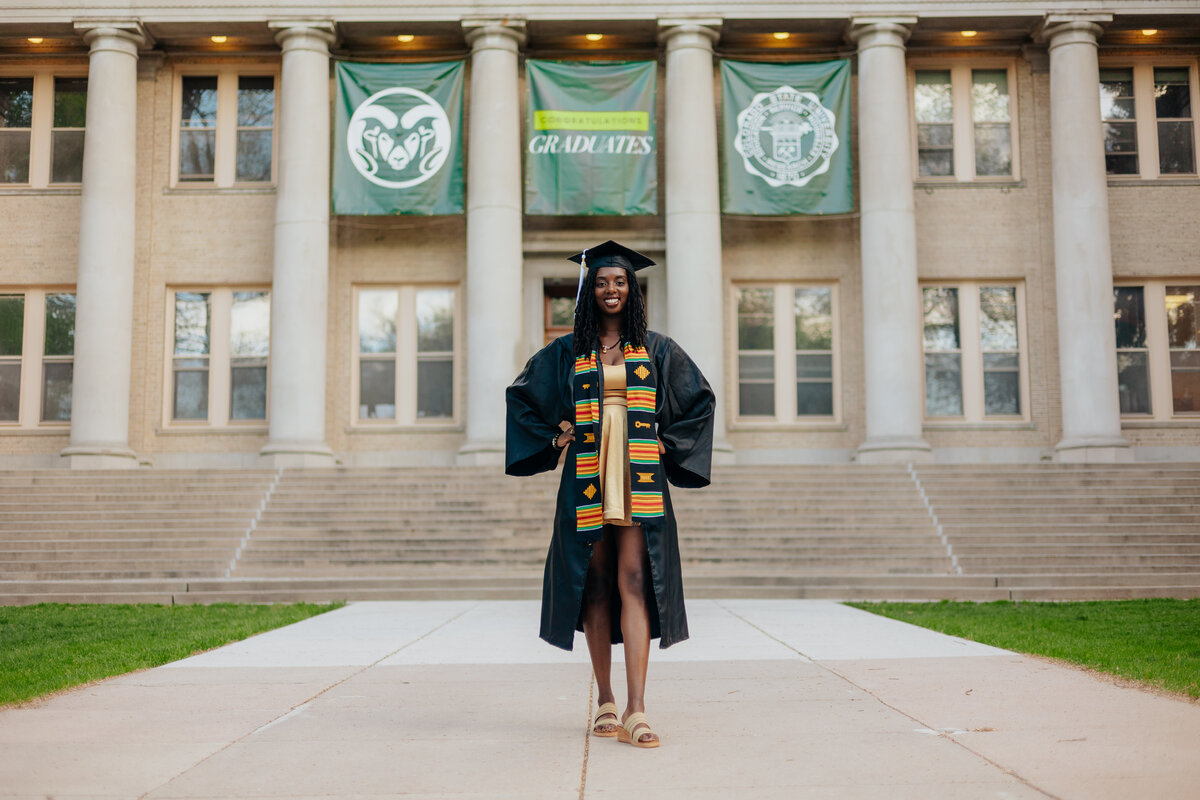 A Colorado State University graduate poses for a photo during her grad session in Fort Collins, Colorado. The picturesque CSU campus serves as a stunning backdrop to her celebration of this milestone achievement.