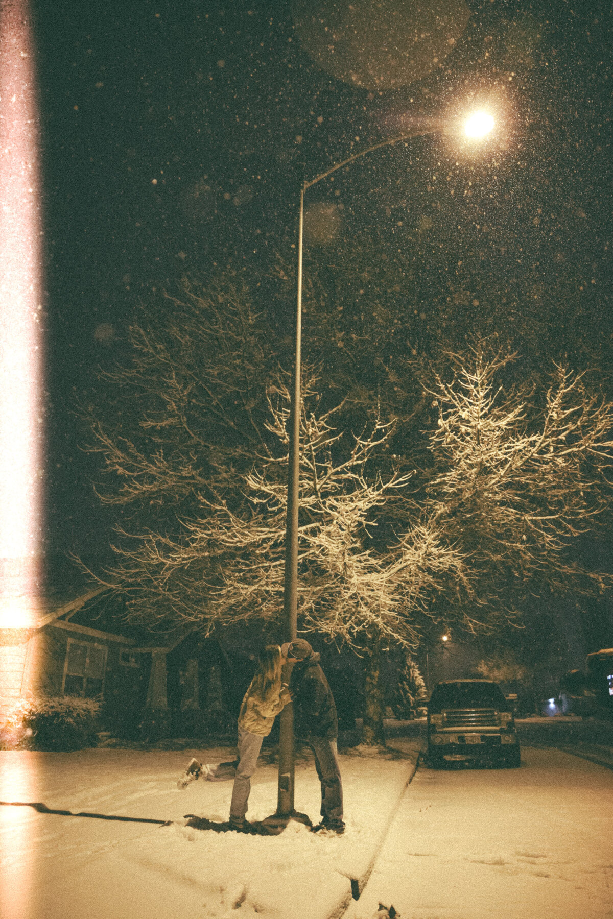 Romantic Snowy Couples Photo Under Streetlight on Winter Night