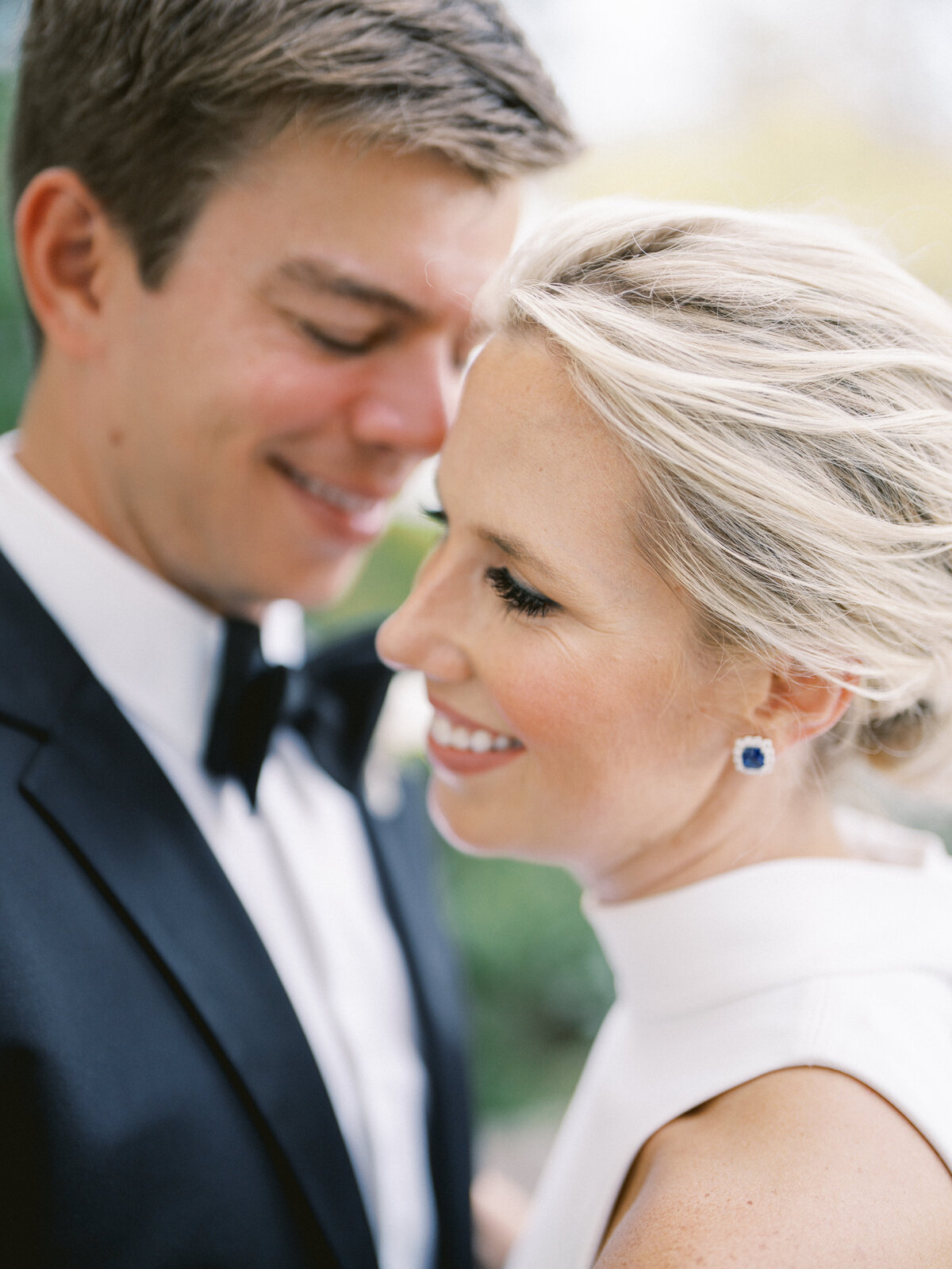 bride with loose updo hair and sapphire earrings wedding photography