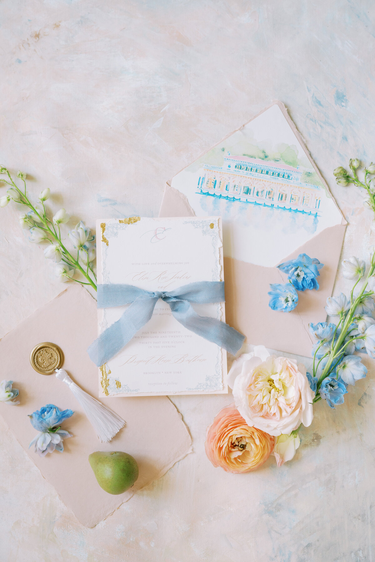 Colorful wedding invitation suite styled with florals at Prospect Park Boathouse.