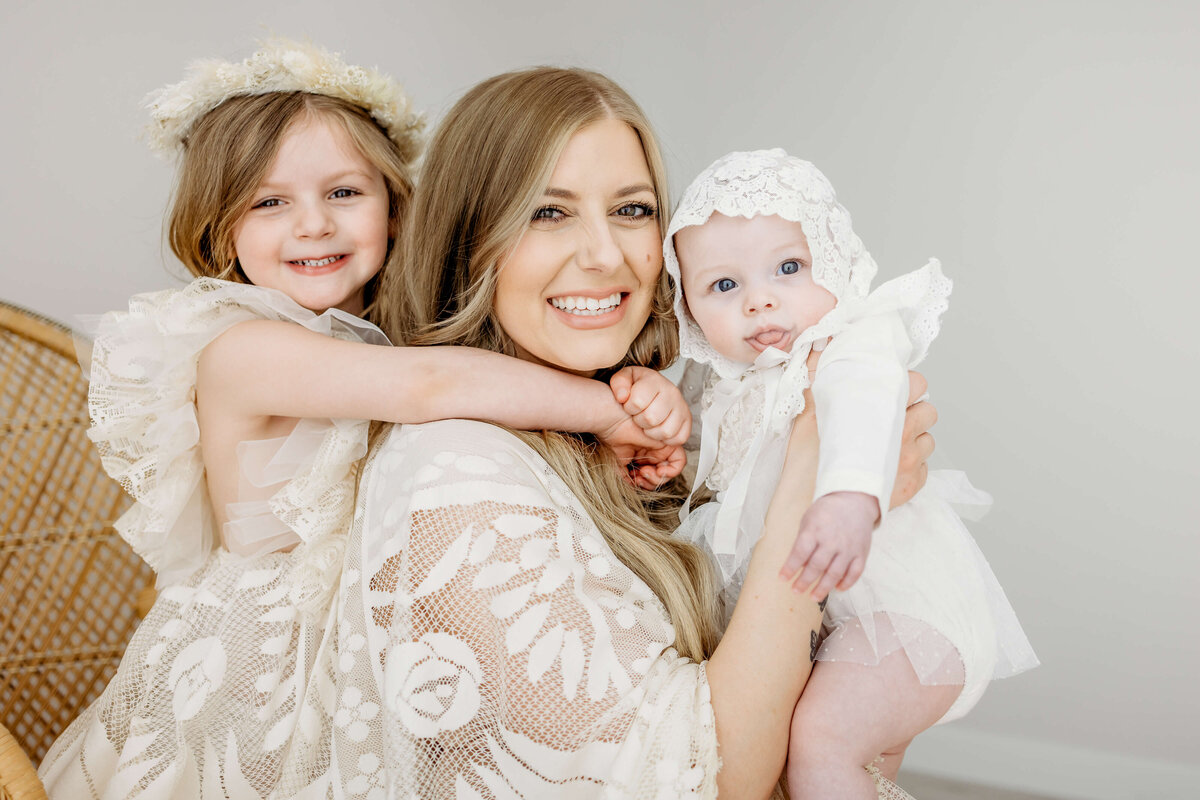 Mom and kids in white in studio near Eau Claire WI, a family photography session