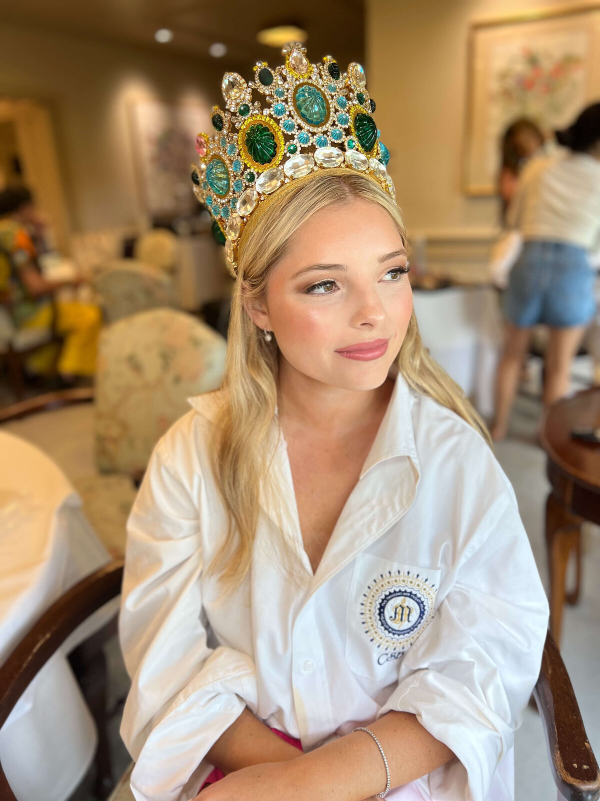 Young woman in jeweled crown with soft glam quinceañera makeup, getting ready for celebration in San Antonio with Mistique Makeup