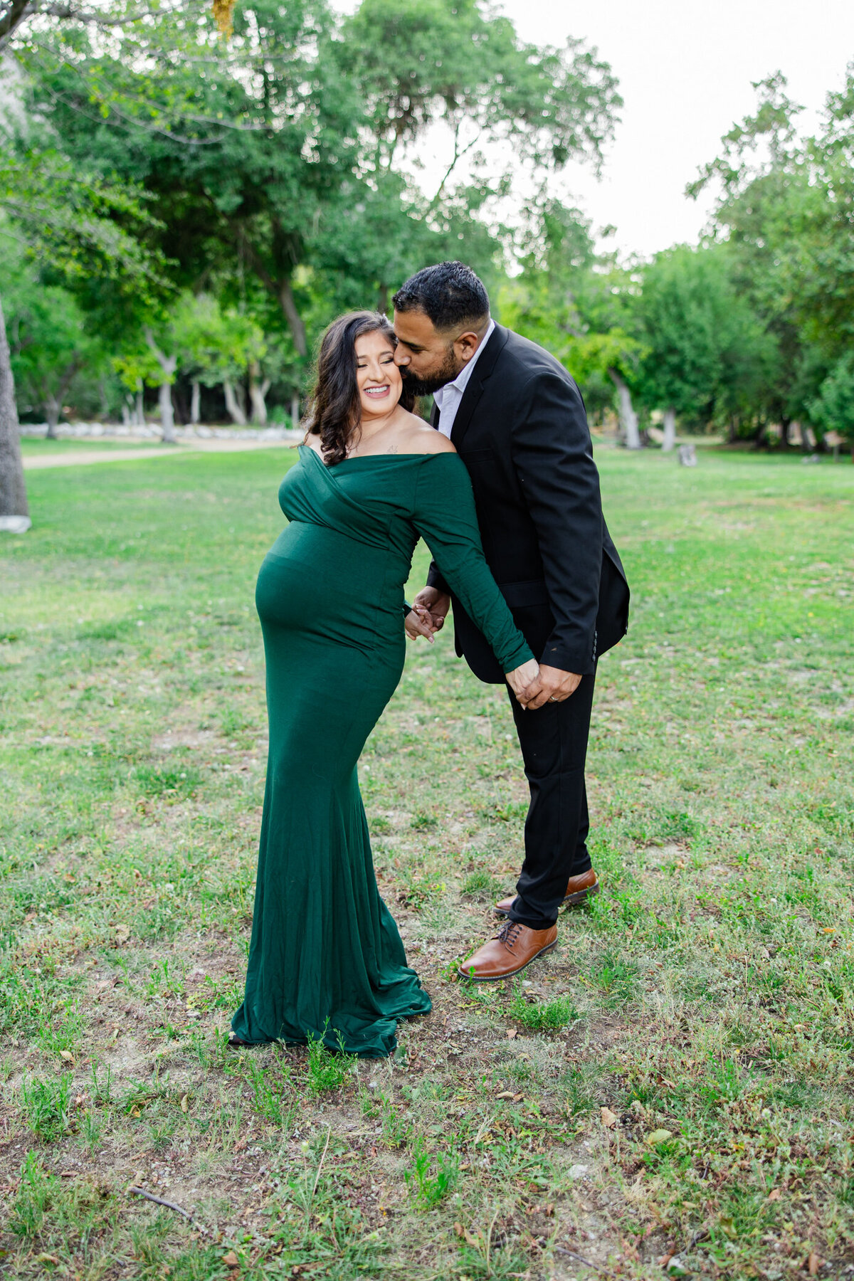 maternity couple hold hands