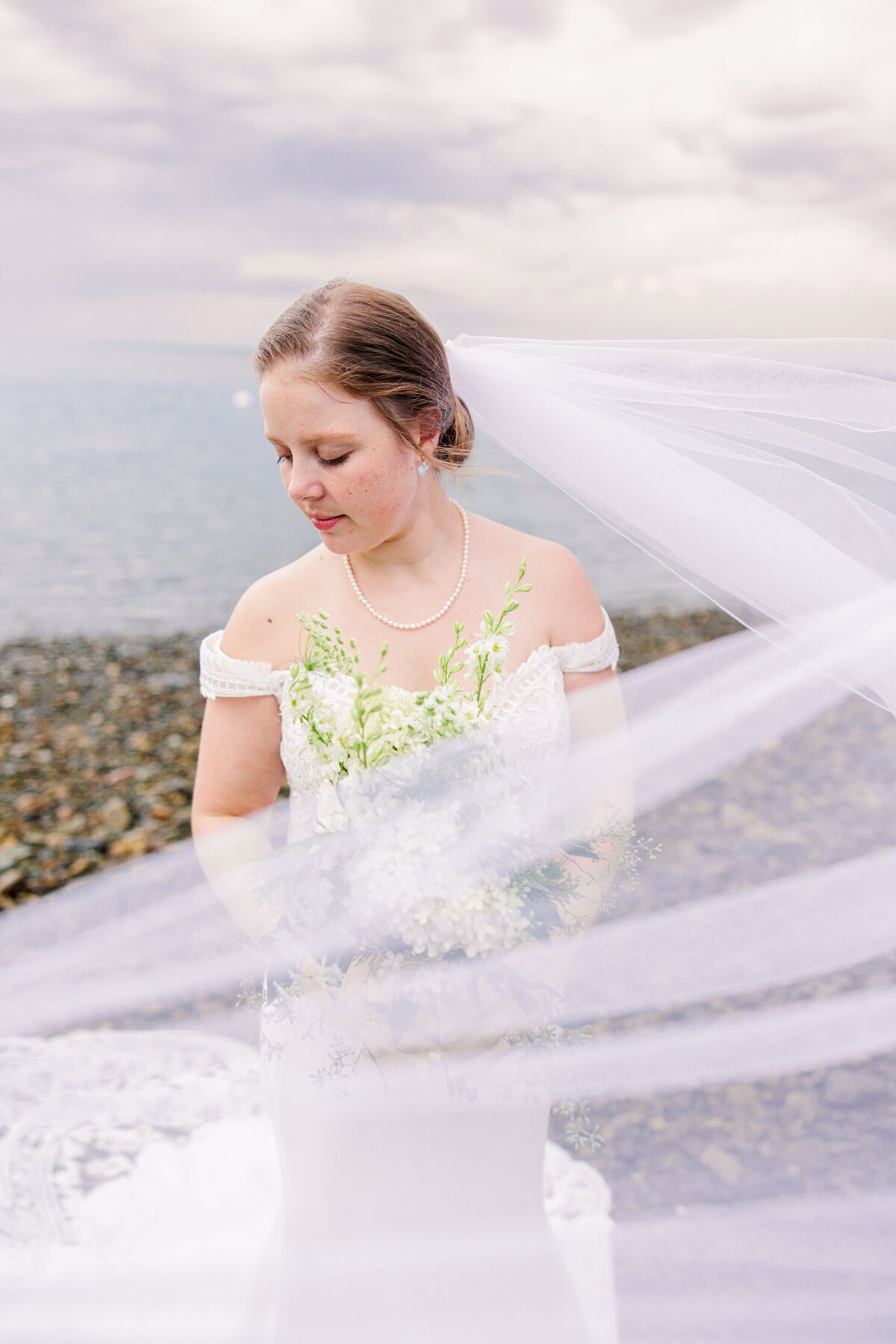 Bridal portrait with the veil blowing in the breeze representing romantic moments during a Boston wedding