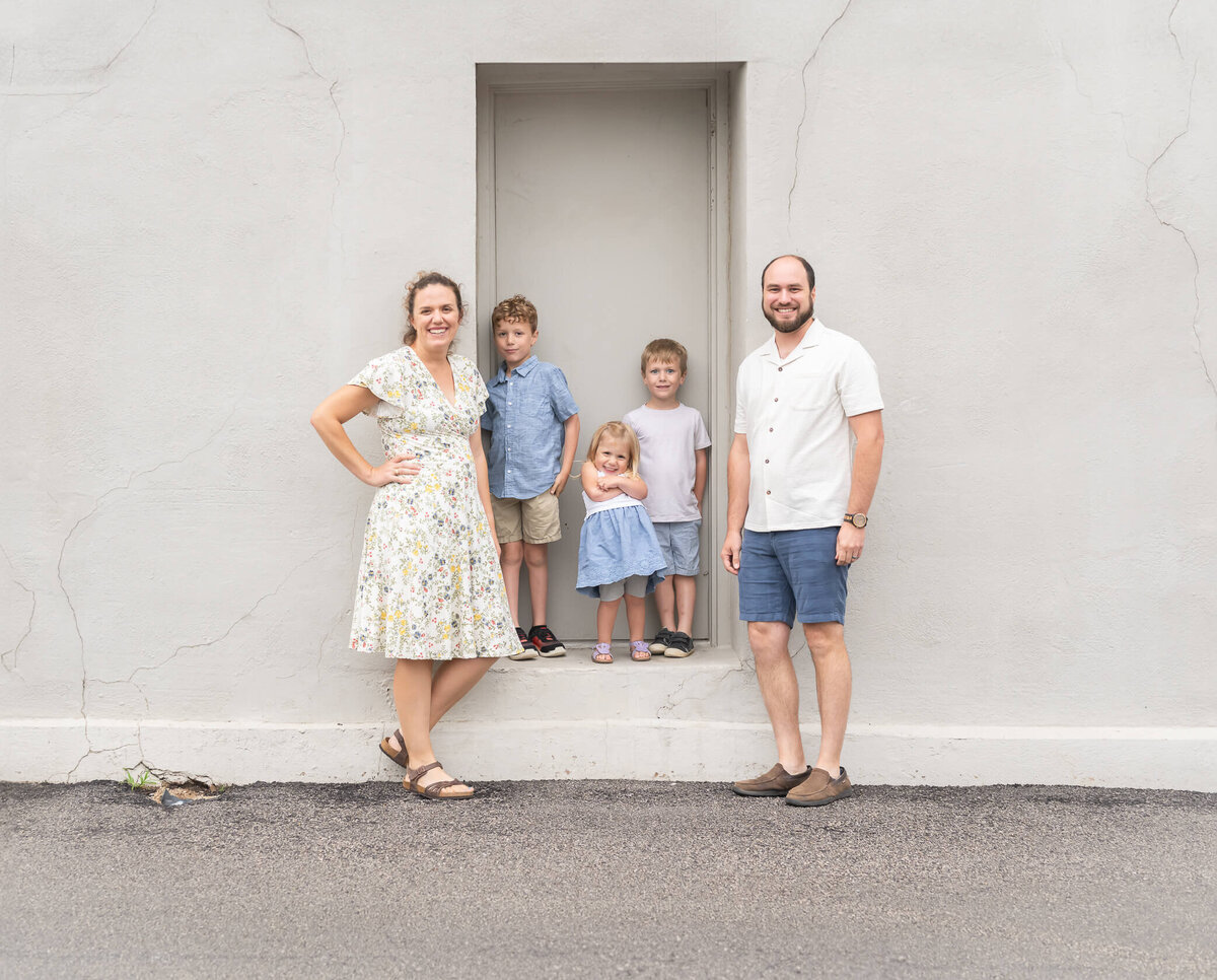 mom and dad with all little kids in a family portrait downtown