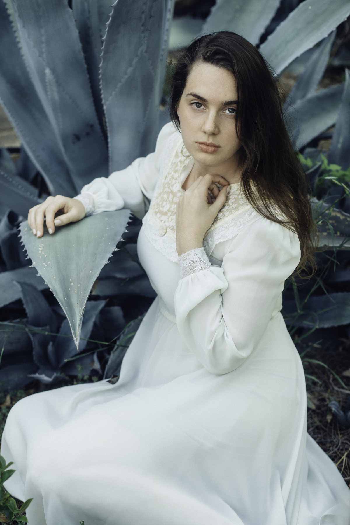 Portrait Photo Of Young Woman In White Dress Holding Her Neck Los Angeles