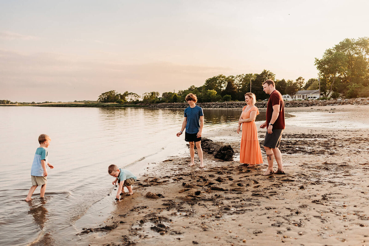 family of five exploring on a beach in Delaware.  photo taken by Cape May Photographer, Kristi