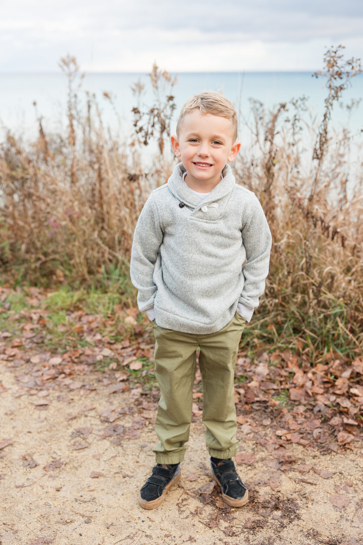 Little boy standing with hands in his pockets