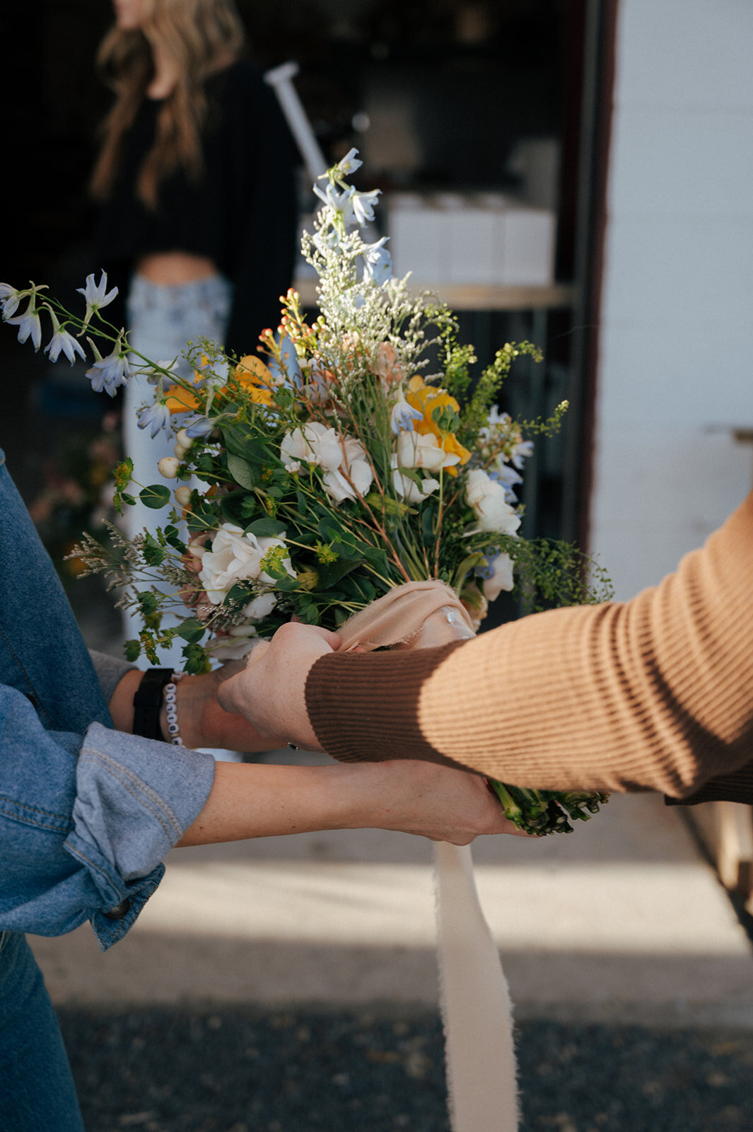 Two people hold up a bouquet of flowers for a vow renewal in Boise. 
