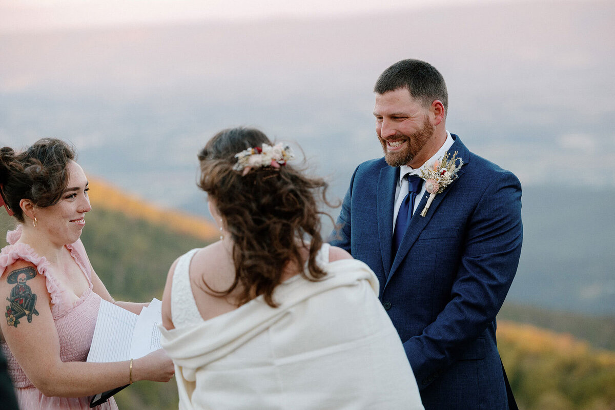 A groom laughs during his elopement ceremony. 