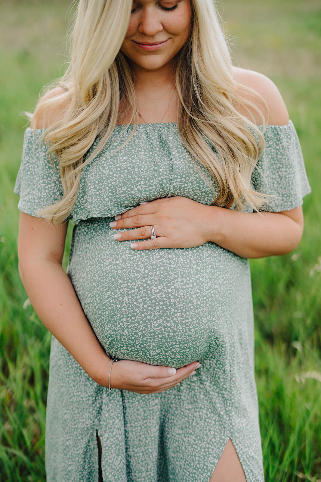 woman holding baby bump at  maternity session in Finger Lakes, New York