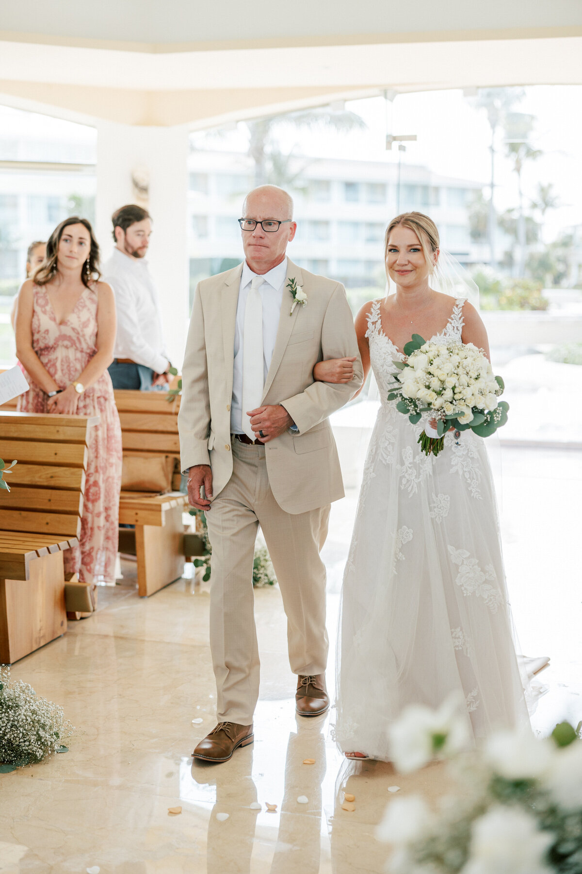 Bride walks down the aisle with father at Cancun wedding, captured by Philadelphia photographer.