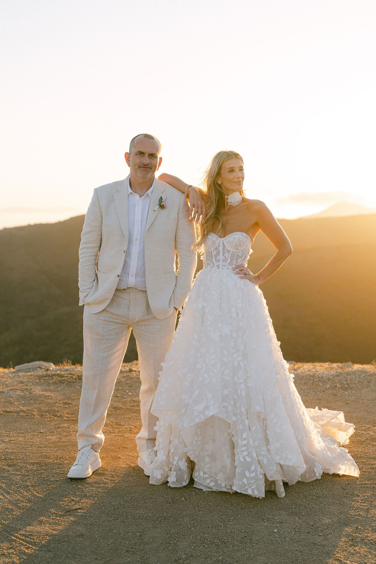 Bride with her elbow on the groom's shoulder in an editorial pose taken during golden hour  at Deer Creek Ridge Malibu wedding venue
