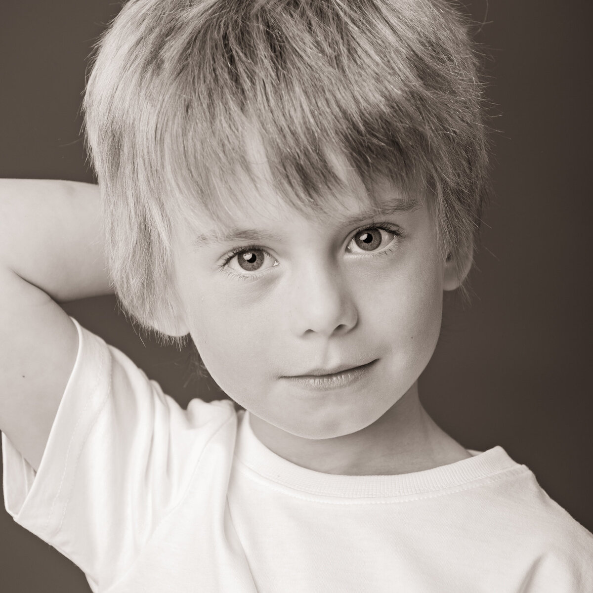 black & white photograph of a child wearing a white t shirt