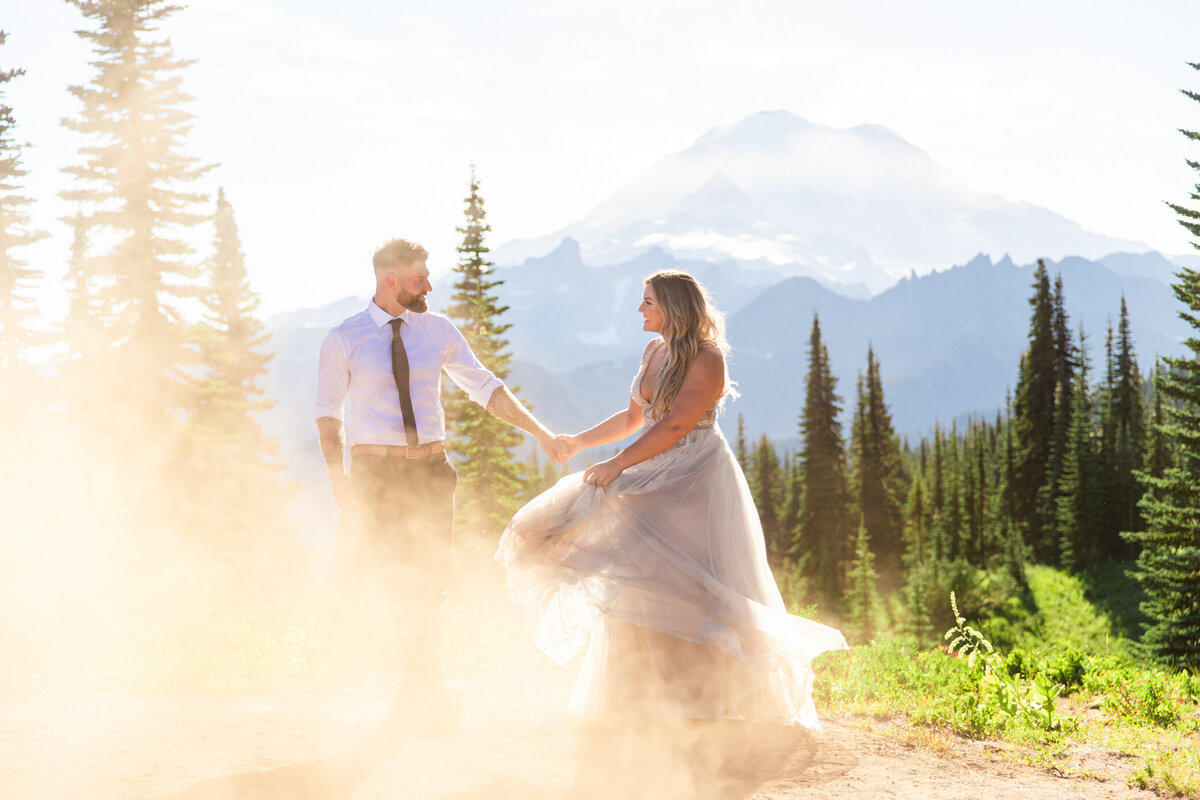 bride and groom dance on a mountain top