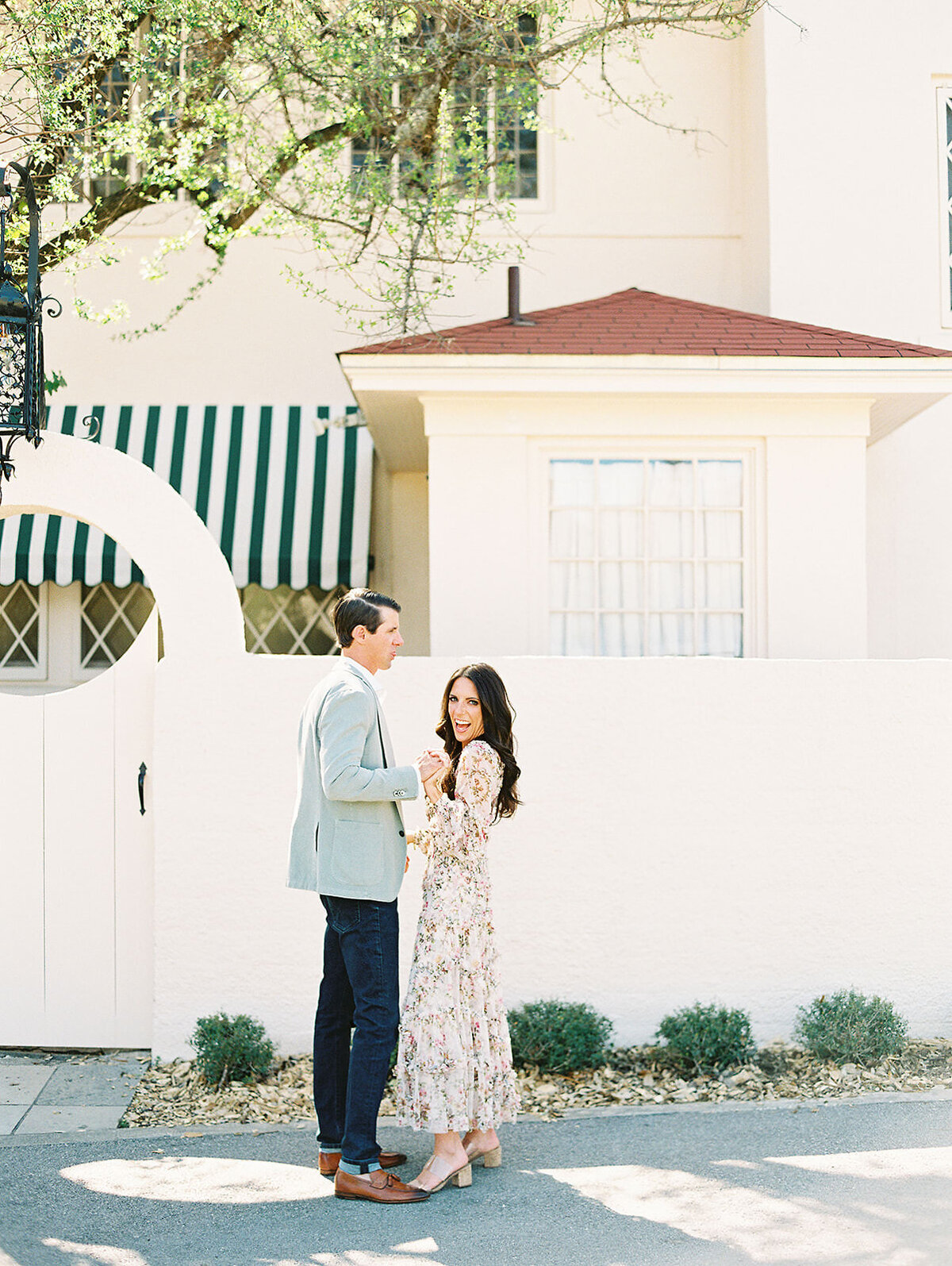 stylish couple laughs together for their spring engagement photos