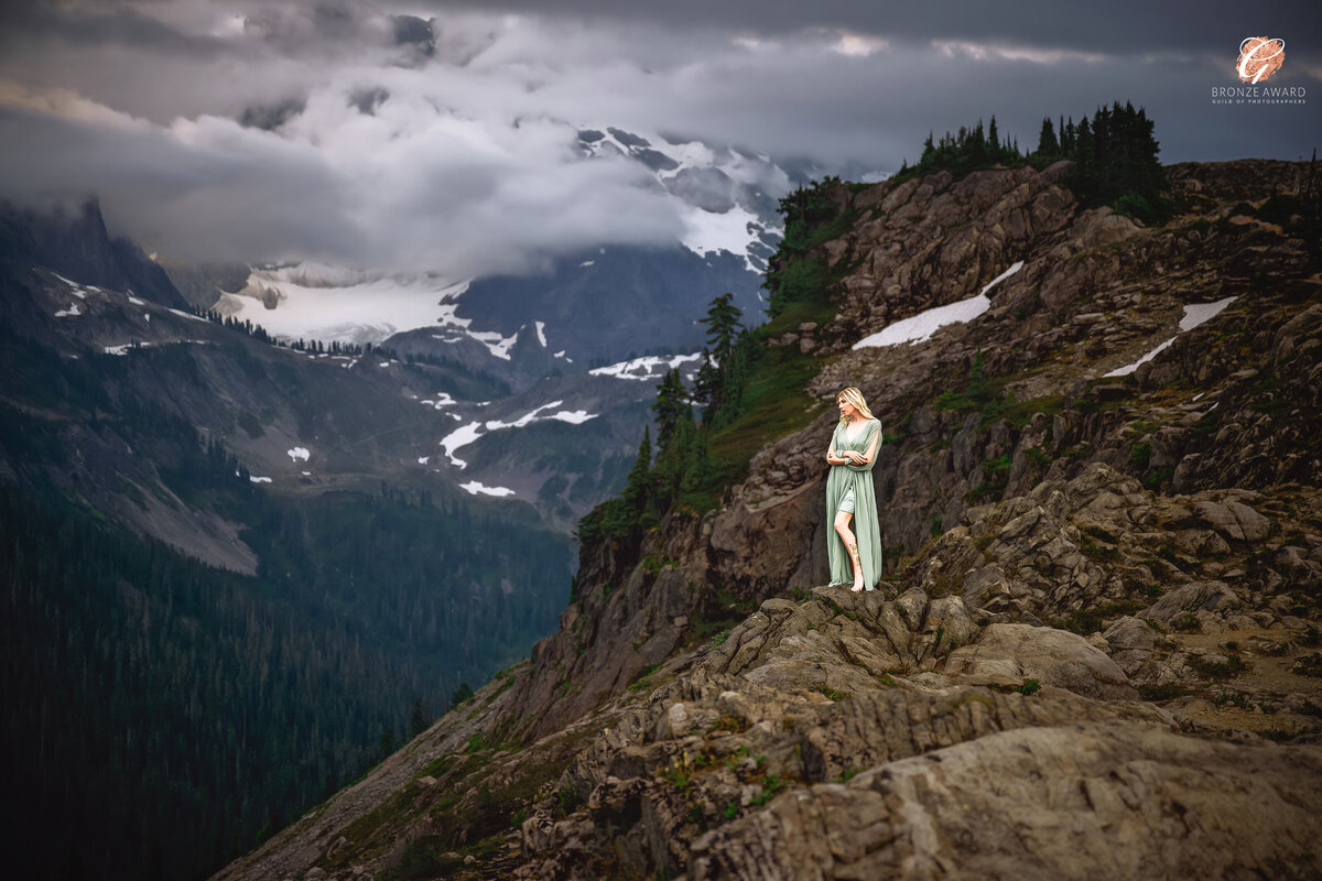 Inspired by the beauty of nature and Greek mythology, “Echoes of Psyche” showcases an ethereal figure standing gracefully amidst the rugged mountain landscape. This breathtaking fine art portrait, taken by Pets through the Lens Photography in Vancouver, received the Bronze Award from the Guild of Photographers. The dramatic contrast between the serene model and the vast wilderness highlights the photographer’s mastery in capturing both human emotion and natural grandeur. For those seeking award-winning fine art portraiture or stunning landscape photography in Vancouver, Pets through the Lens Photography delivers unparalleled artistry.