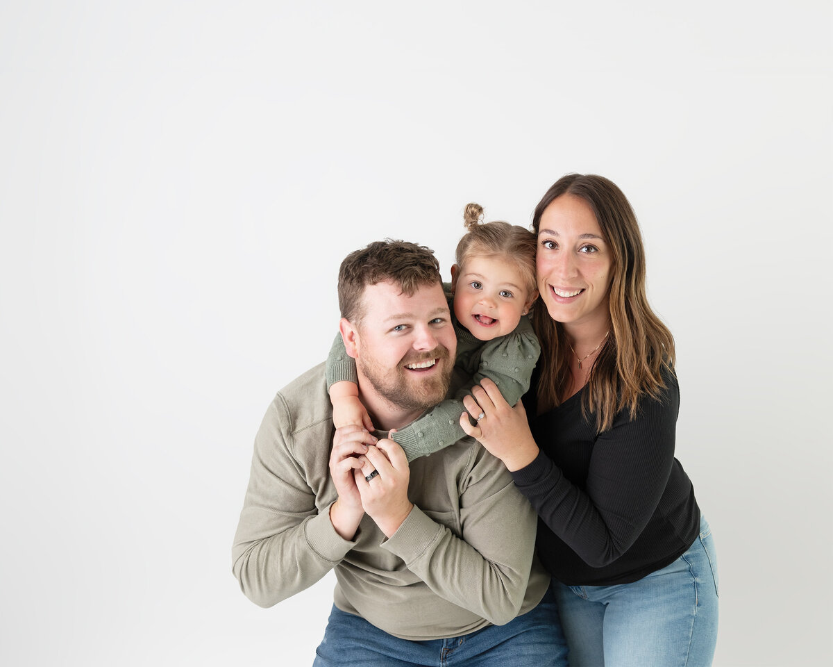Playful studio in Paris, Ontario family photo with daughter hugging her dad | Paris Ontario photographer