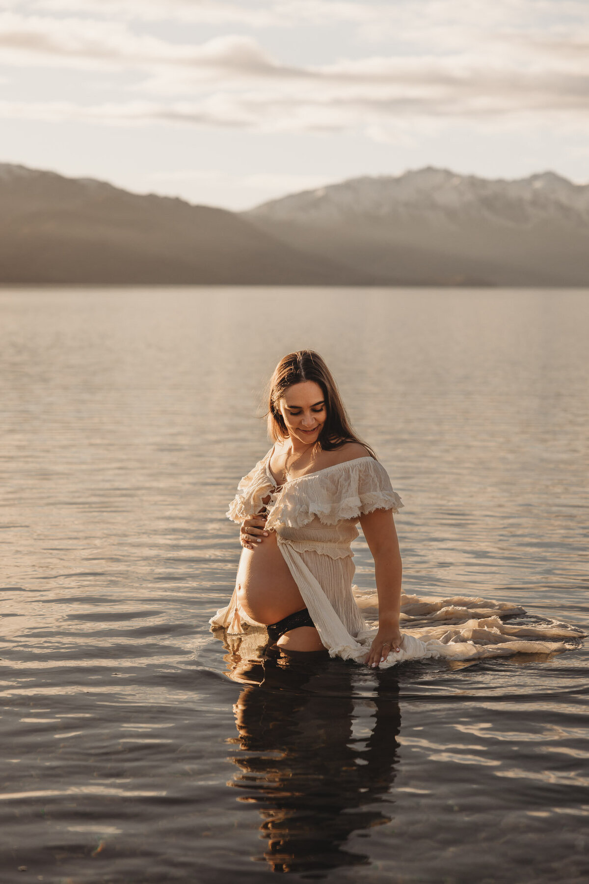 pregnant woman standing in the lake during her maternity session