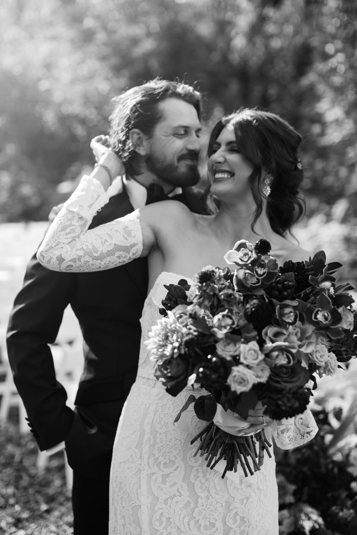 extremely happy bride and groom right after ceremony  portrait in black and white 