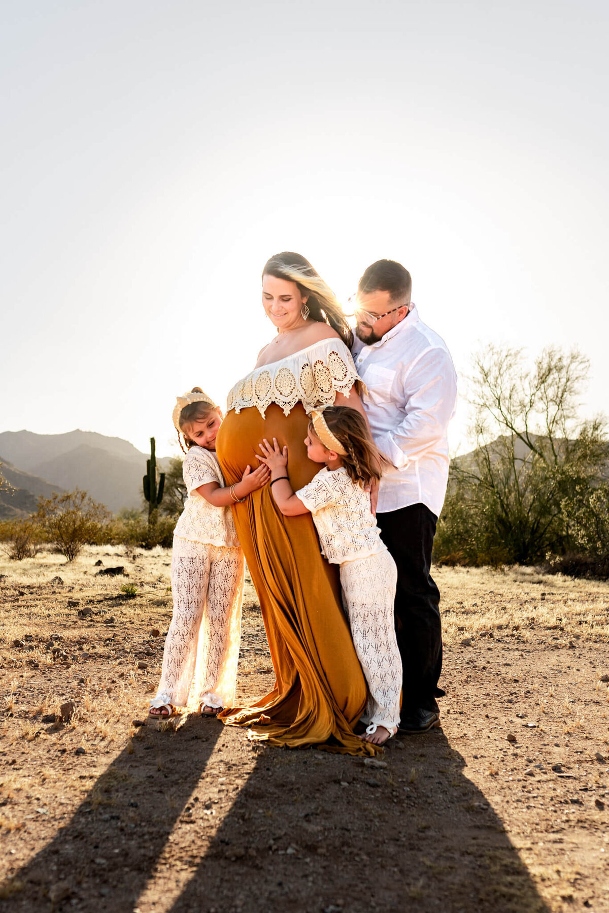 Expecting Arizona mom being embraced from all sides by her family.