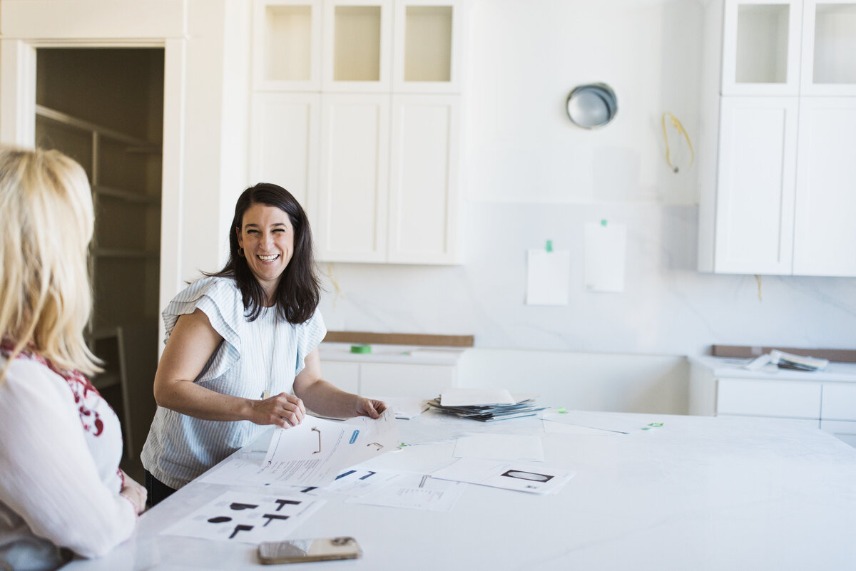woman meeting with interior designer. kitchen under construction, white kitchen