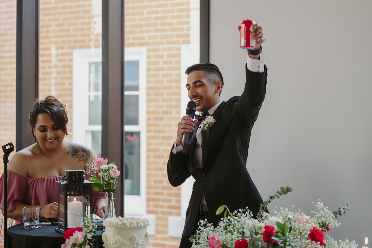 groom tosting guests at reception