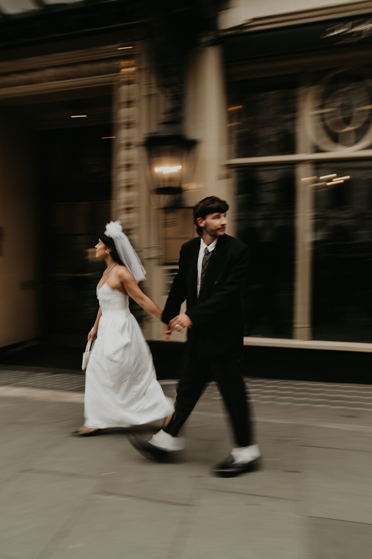 A wedding couple walk the streets of London.