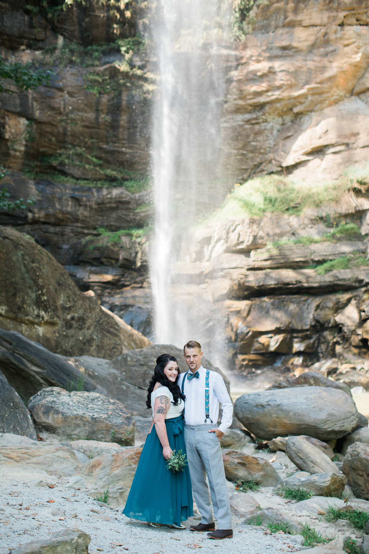 Wedding Photographer, couple standing in front of a waterfall