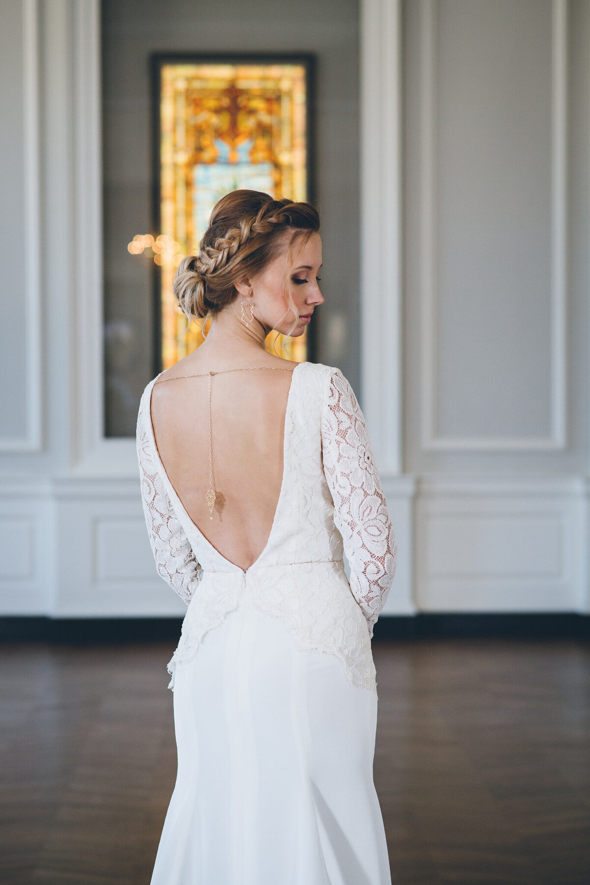 The center of the low v-back on the Bibi wedding dress style guides your eye down to the peak of the lace scallop edge just below the waistline.
