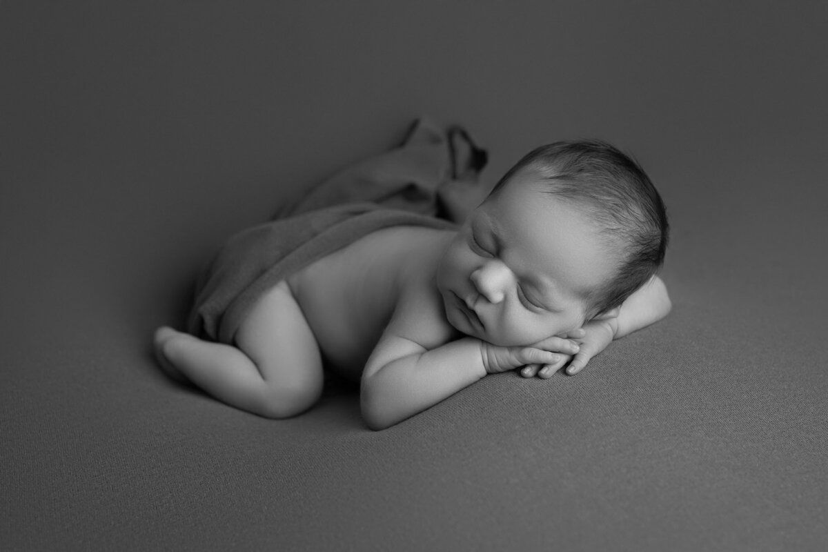 Black white newborn tummy time pose Cedar Park artistic baby photographer