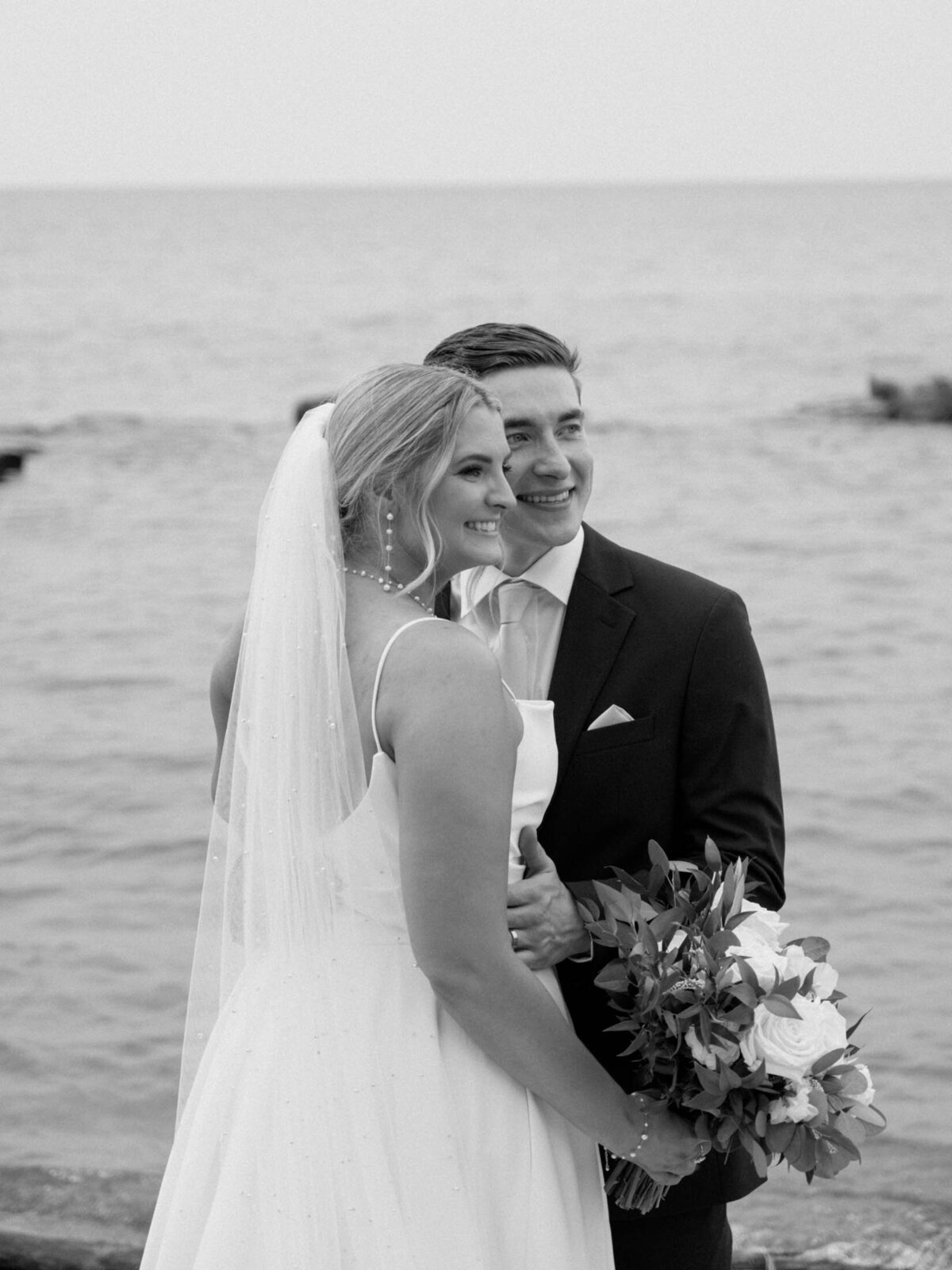 Bride and groom with lake in the background