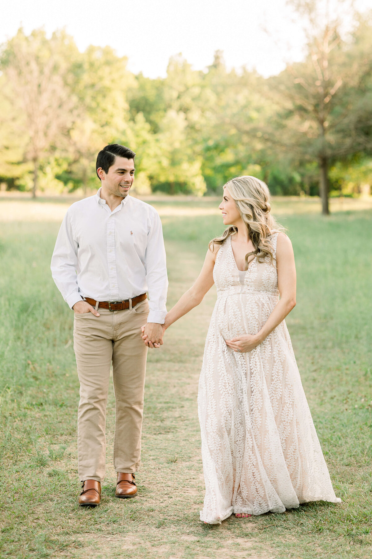 a pregnant woman holding hands with her husband