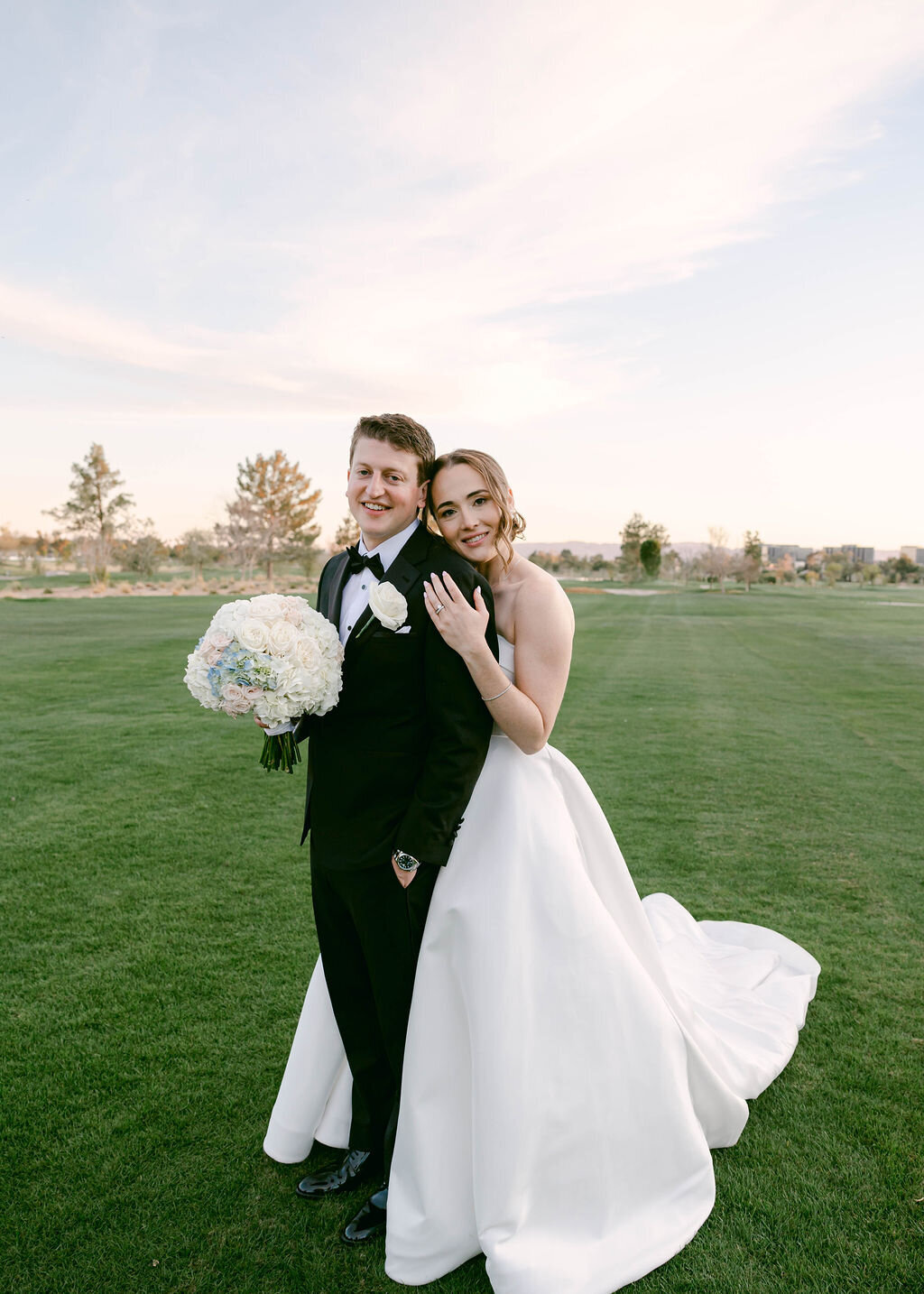 Bride and groom sunset portrait on the lawn at a golf club in Scottsdale, Arizona. 