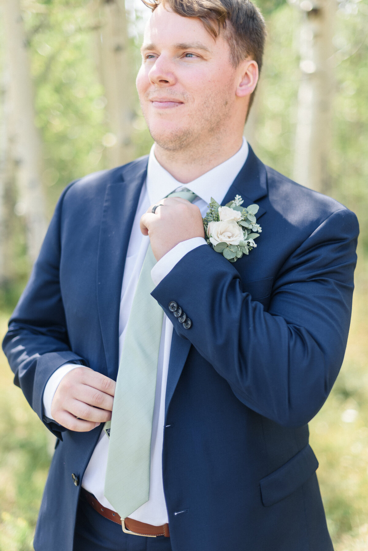 Summer Granby Wedding at the summit. Grooms portraits, blue suit, and sage tie.