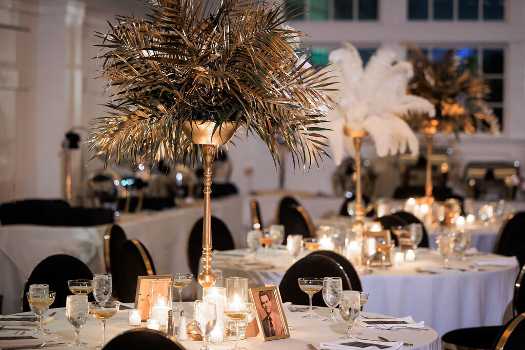 Gold palm and white feather Gatsby centerpieces at Park Avenue Club in Florham Park, NJ
