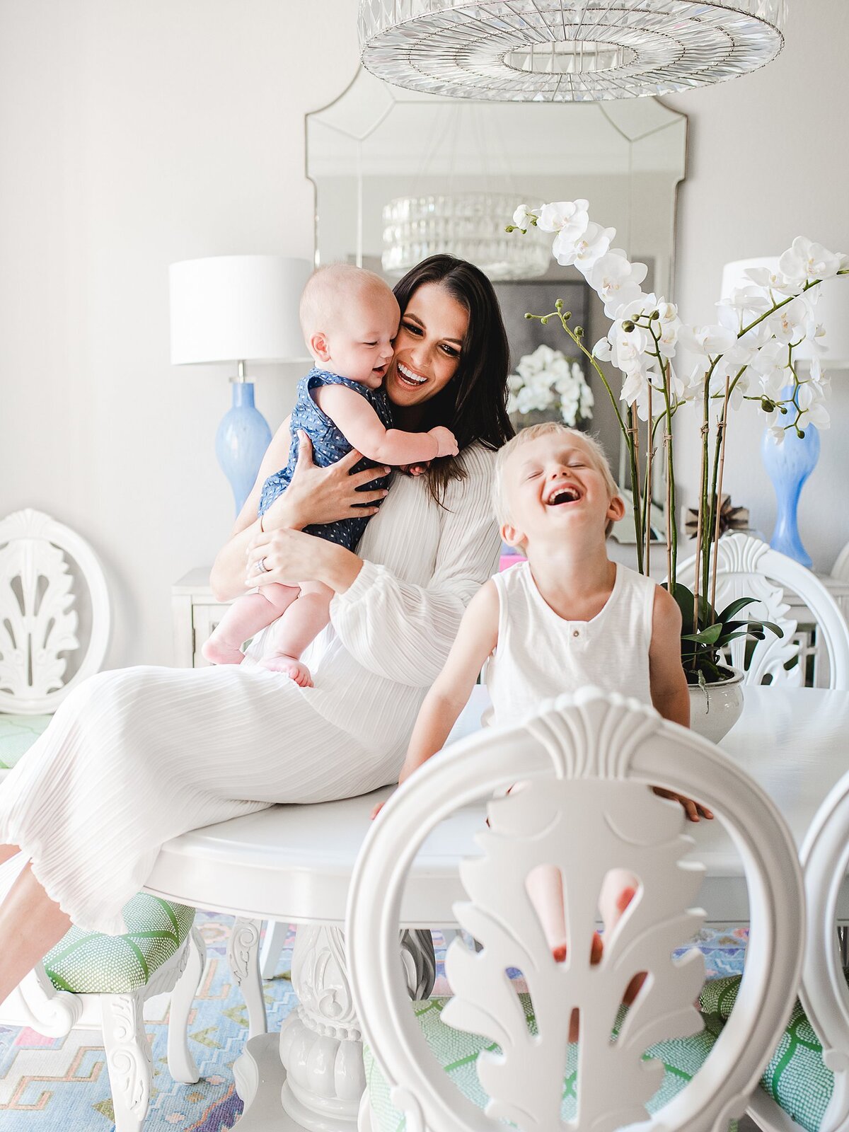 White dining room table with mom and baby and son