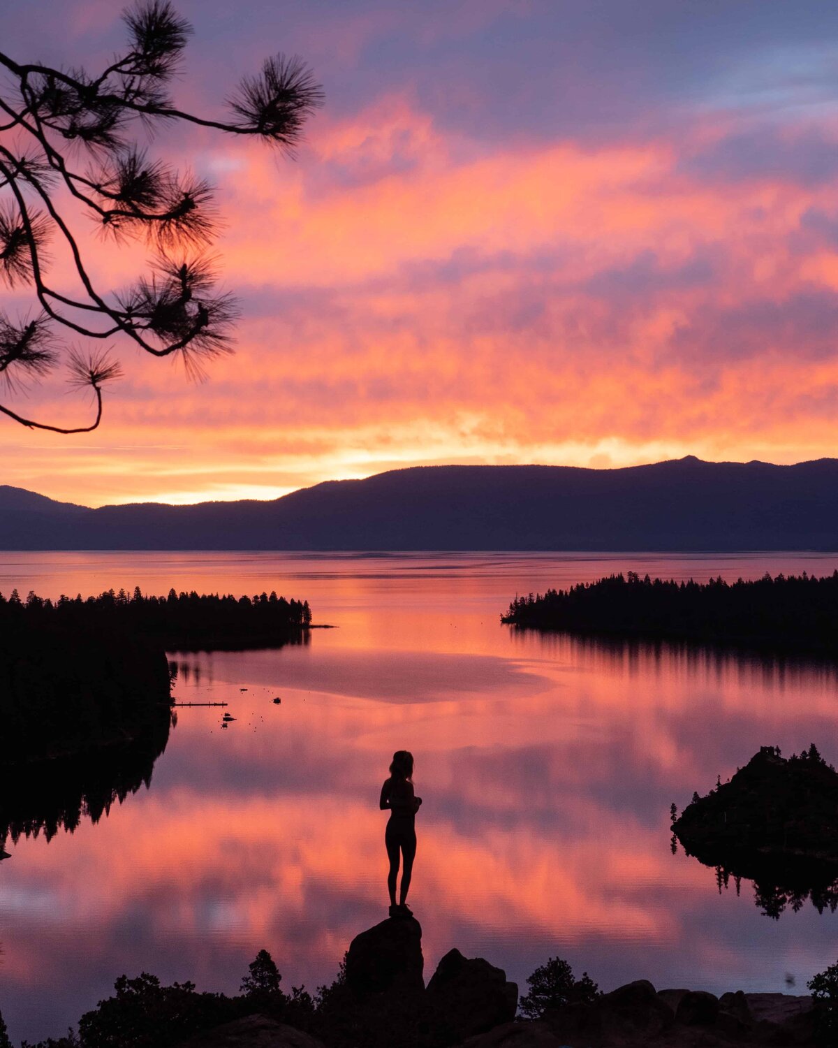 Silhouette of a woman standing in front of Lake Tahoe at sunset
