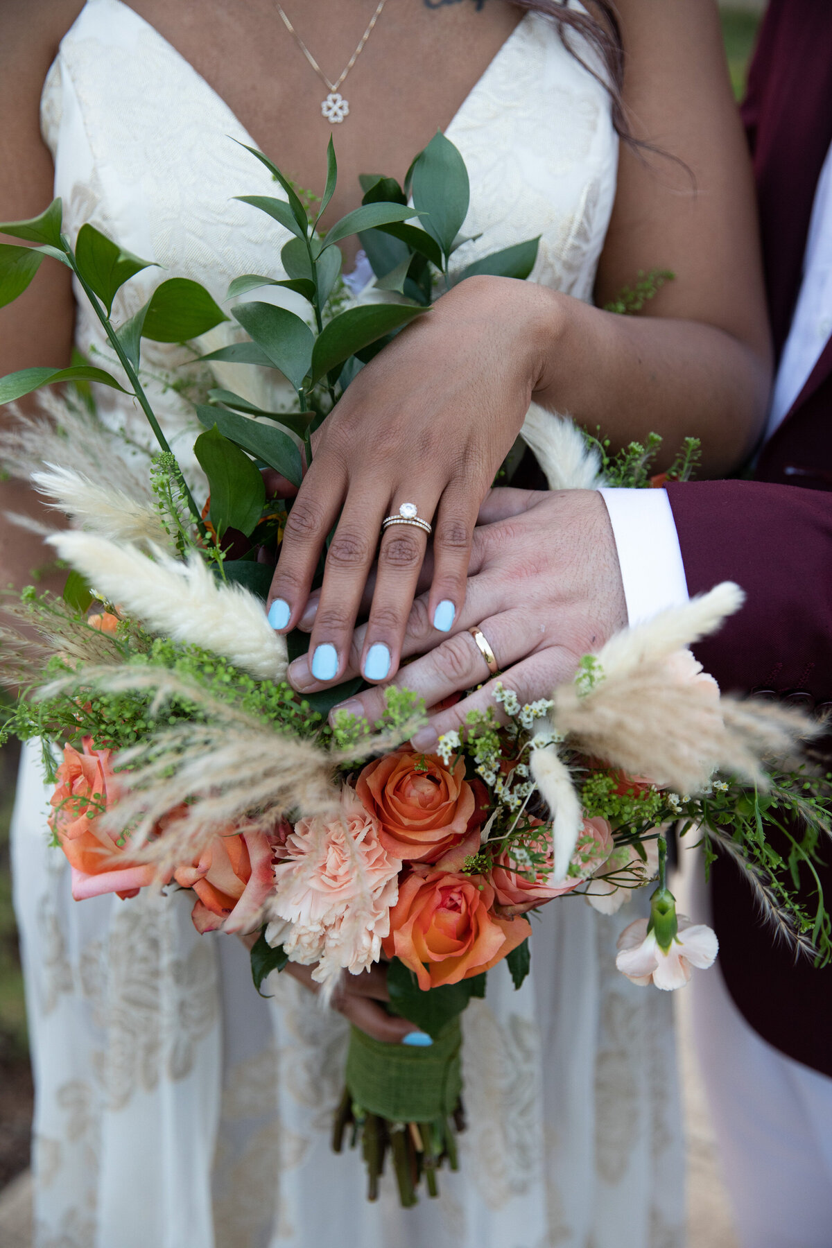 A bride and groom captured by an expert Austin wedding photographer, holding a beautiful bouquet of flowers.