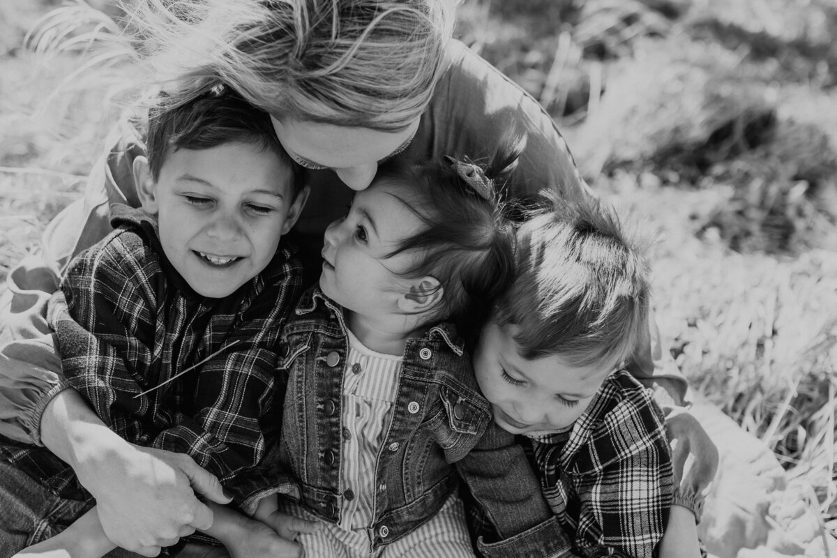 BLACK AND WHITE MOTHER WITH HER CHILDREN