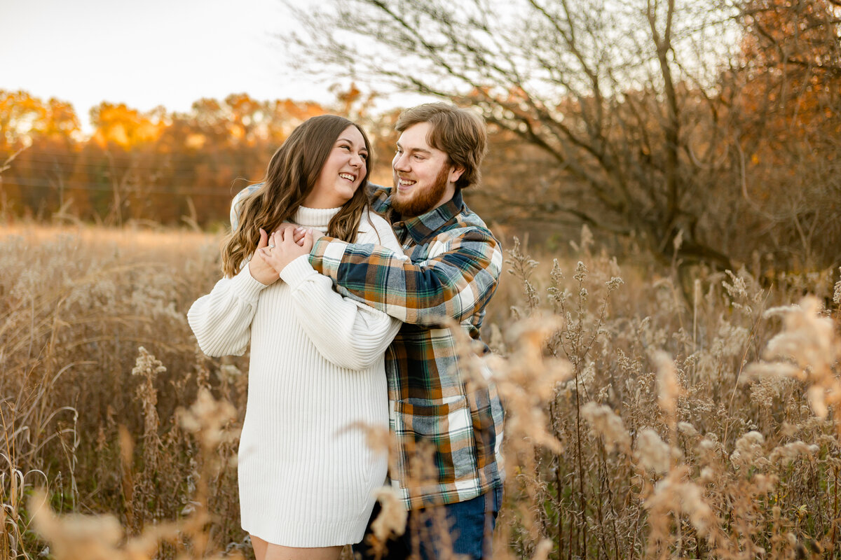 Romantic fall-themed engagement photo captured by Style & Grace Photography at Towne Park, Foristell, MO, showcasing the couple amidst autumn’s vibrant colors.
