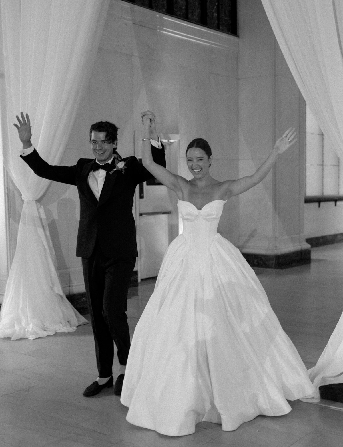 newlywed couple cheers as they enter their State Savings Bank wedding reception in Detroit