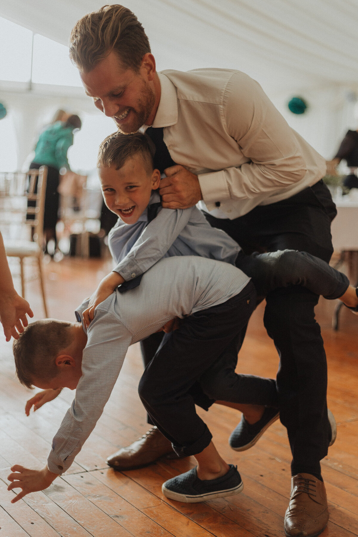 wedding guests playing with kids on the dancefloor