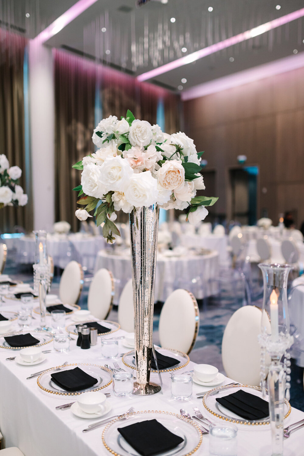 Luxurious baby pink and white wedding florals for wedding reception centrepieces.