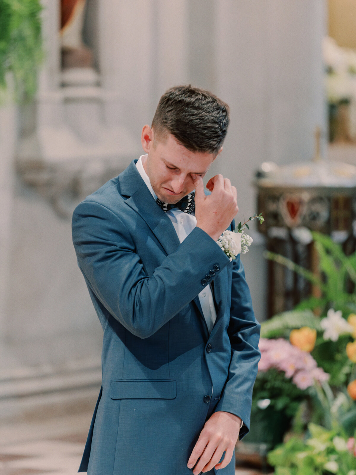 Groom crying when he sees bride during St Cecilia Catholic Church wedding in Cincinnati, Ohio