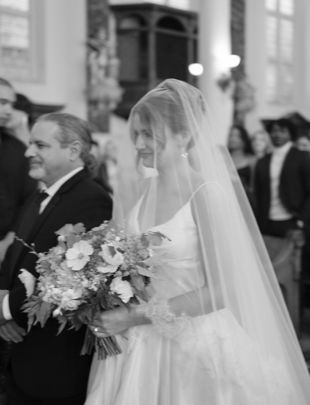 A bride's emotion is seen under her veil as she walks down the aisle for her St. Peter and Paul wedding in Detroit