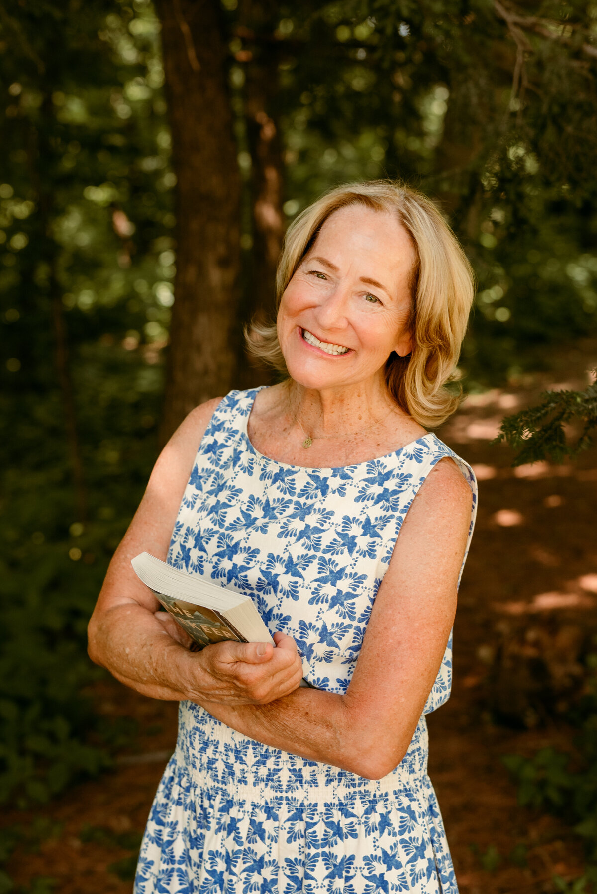 Outdoor online dating portrait of Linda laughing, taken in a leafy Minneapolis park.