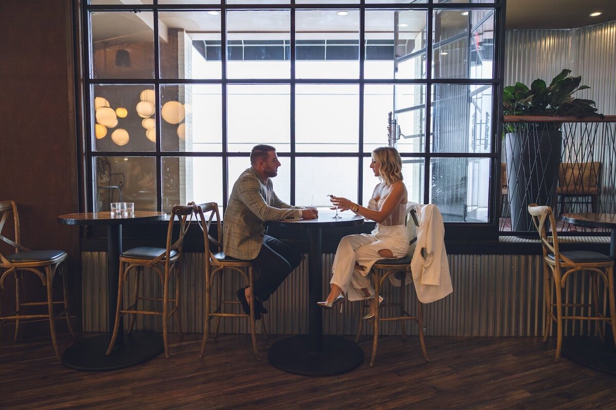 Couple chatting and enjoying drinks in sunlit bar lounge at Felina.